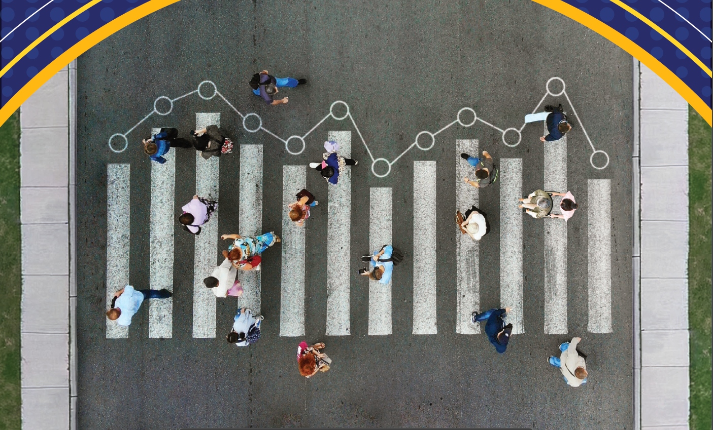 Aerial view of people walking through a crosswalk