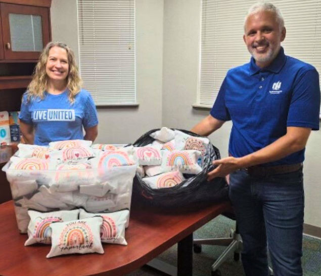 Volunteers posing with hygiene kits